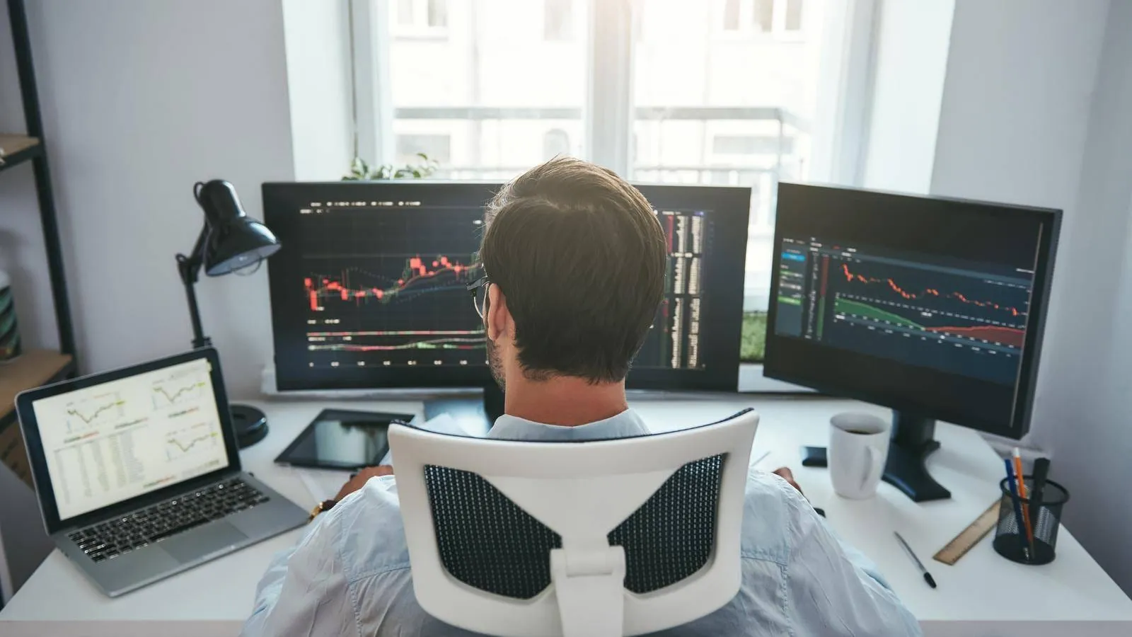 How To Get Into Prop Trading: Launch Your Career at Top Proprietary Trading Firms 4 Back View Of Young Businessman Or Trader Working With Graph And Charts On Computers At His Modern Office