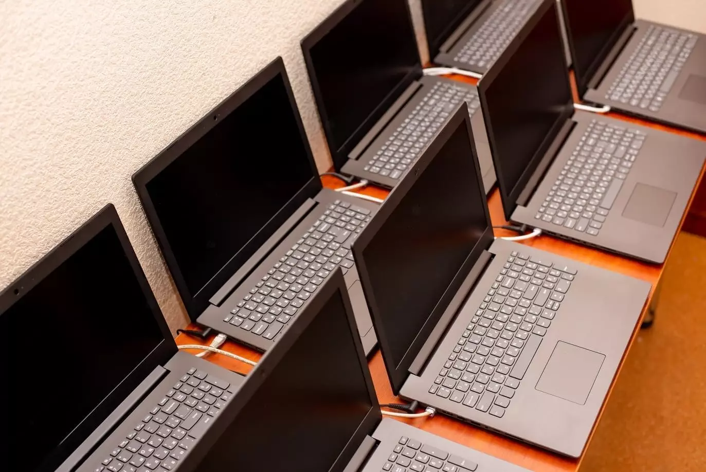 Arranged rows of new laptops for stock trading.